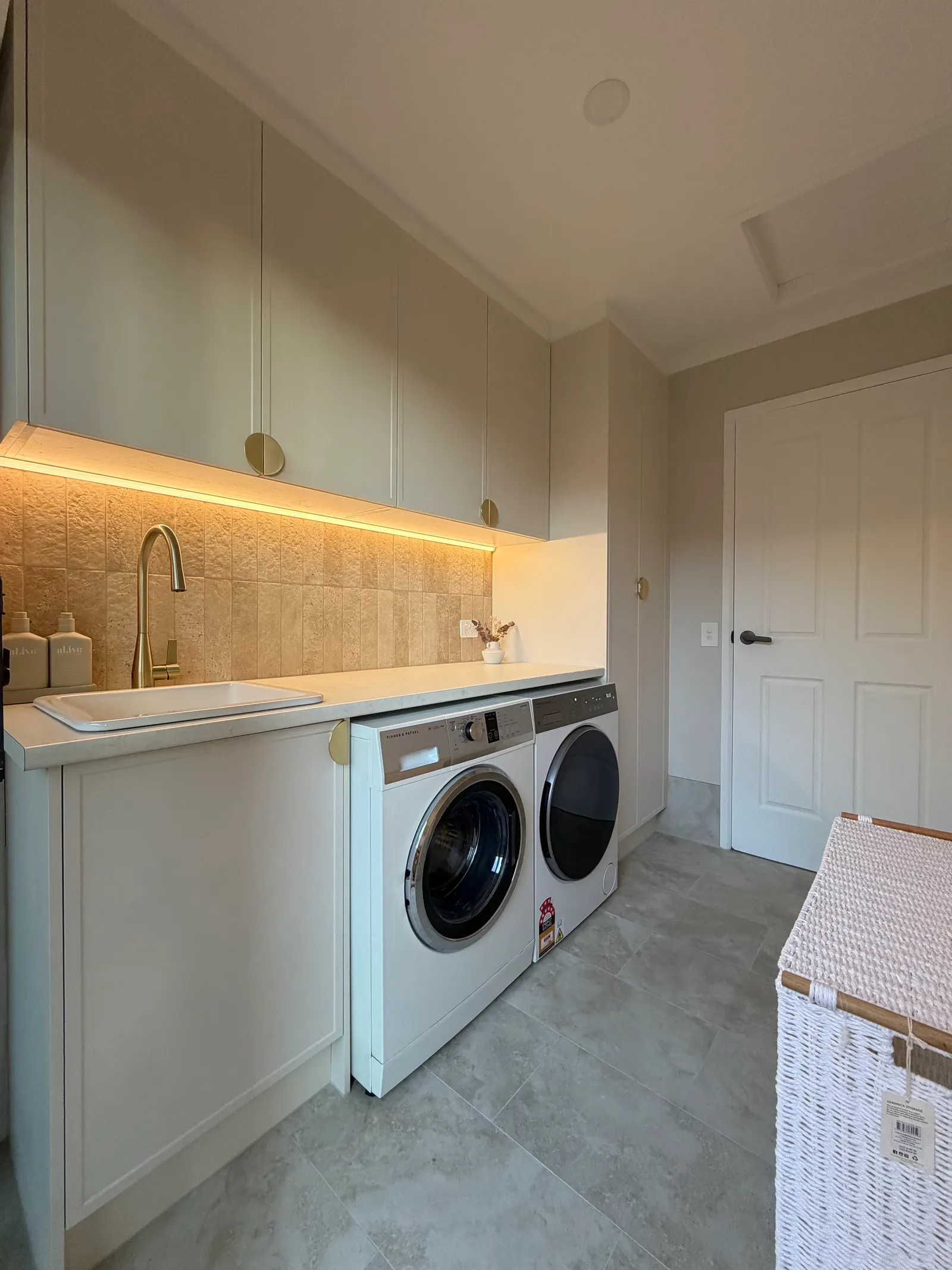 Finished laundry with sink, cabinetry, washer and dryer